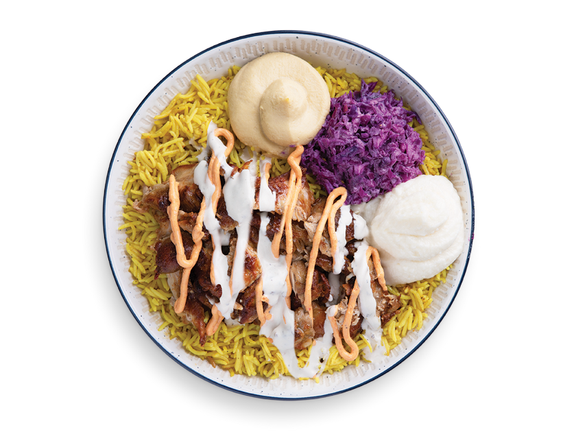Chicken shawarma served over basmati rice with tahini, parsley, tomatoes, pickles and garlic sauce