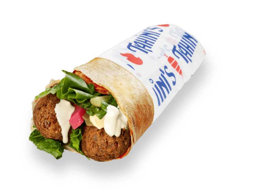 Falafel wrap rolled in saj bread with spicy garlic, turnips, onions, hummus, tomatoes and lettuce