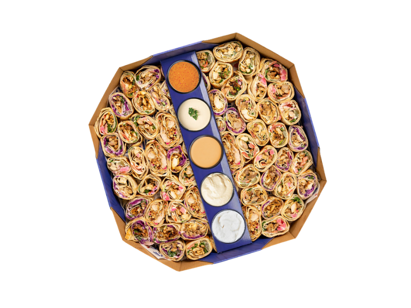 Box of sliced shawarma served with saj bread, pickles and garlic sauce